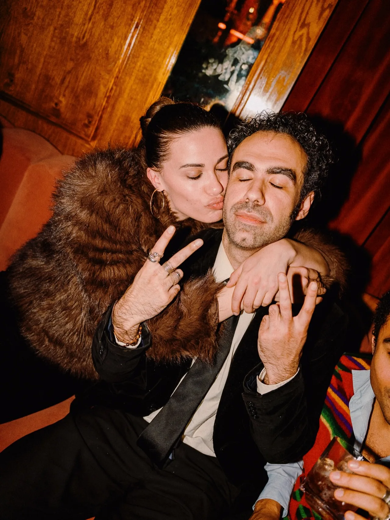 Two guests posing together at the Universe25 UK premiere afterparty
